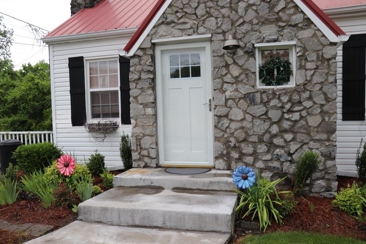 209 Church Street Dover, TN 37058 - Photo 2 of 16 a front view of a house with a yard