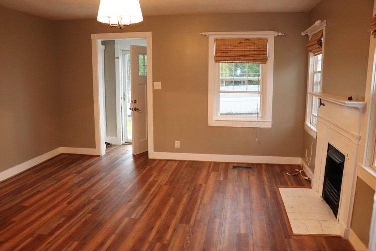 209 Church Street Dover, TN 37058 - Photo 3 of 16 an empty room with wooden floor and a fireplace