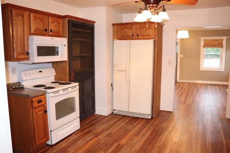 209 Church Street Dover, TN 37058 - Photo 4 of 16 a view of a kitchen with wooden floor and electronic appliances