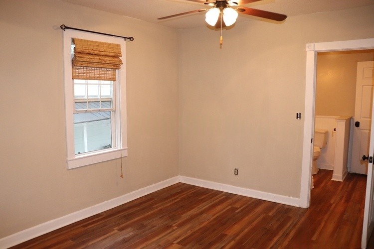 209 Church Street Dover, TN 37058 - Photo 8 of 16 a view of an empty room with wooden floor and a window