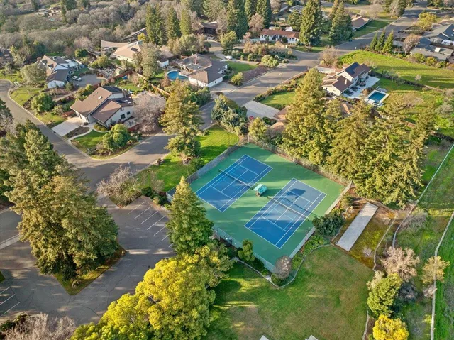 an aerial view of a residential houses with outdoor space