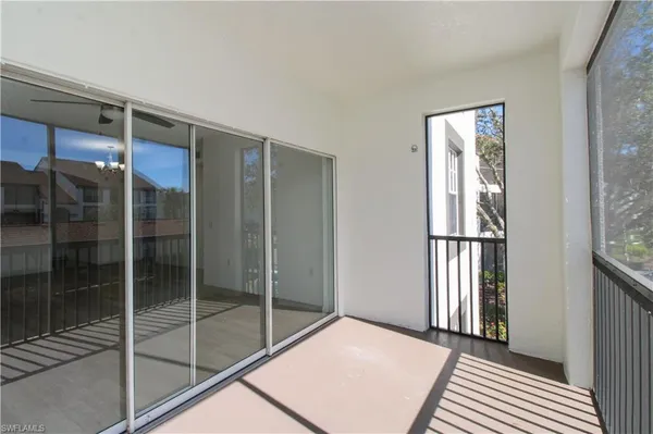 a view of an empty room with glass door