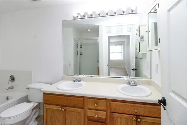 a bathroom with a sink toilet a mirror and shower