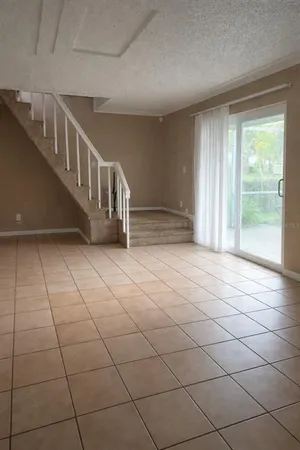 a view of a livingroom with an empty space and a window