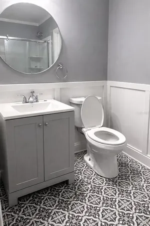 a bathroom with a toilet and a mirror