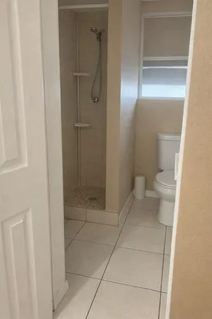 a bathroom with a glass shower door