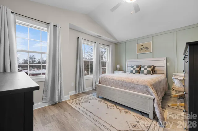 a bedroom with a large bed and a window