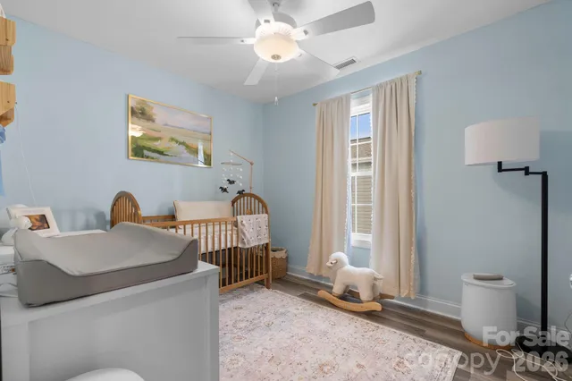 a living room with furniture a window and a chandelier