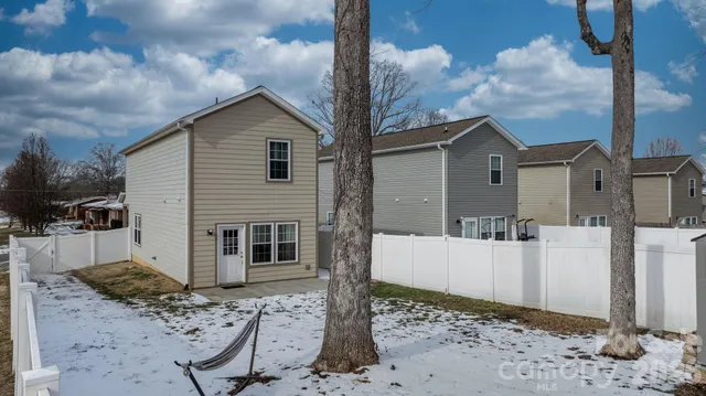 a view of a house with wooden fence