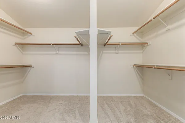 an empty room with a fan and a fan