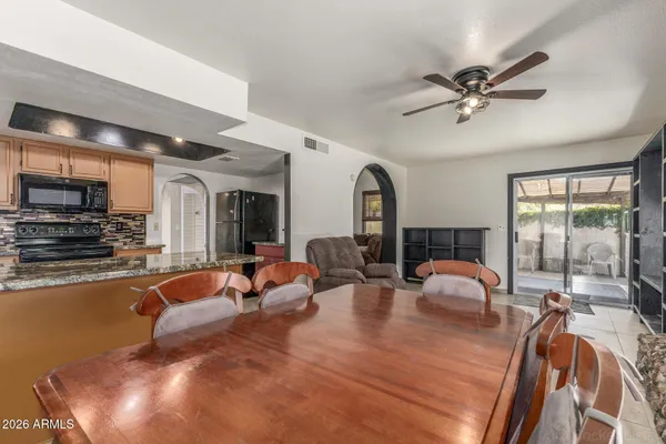 a dining room with furniture and window