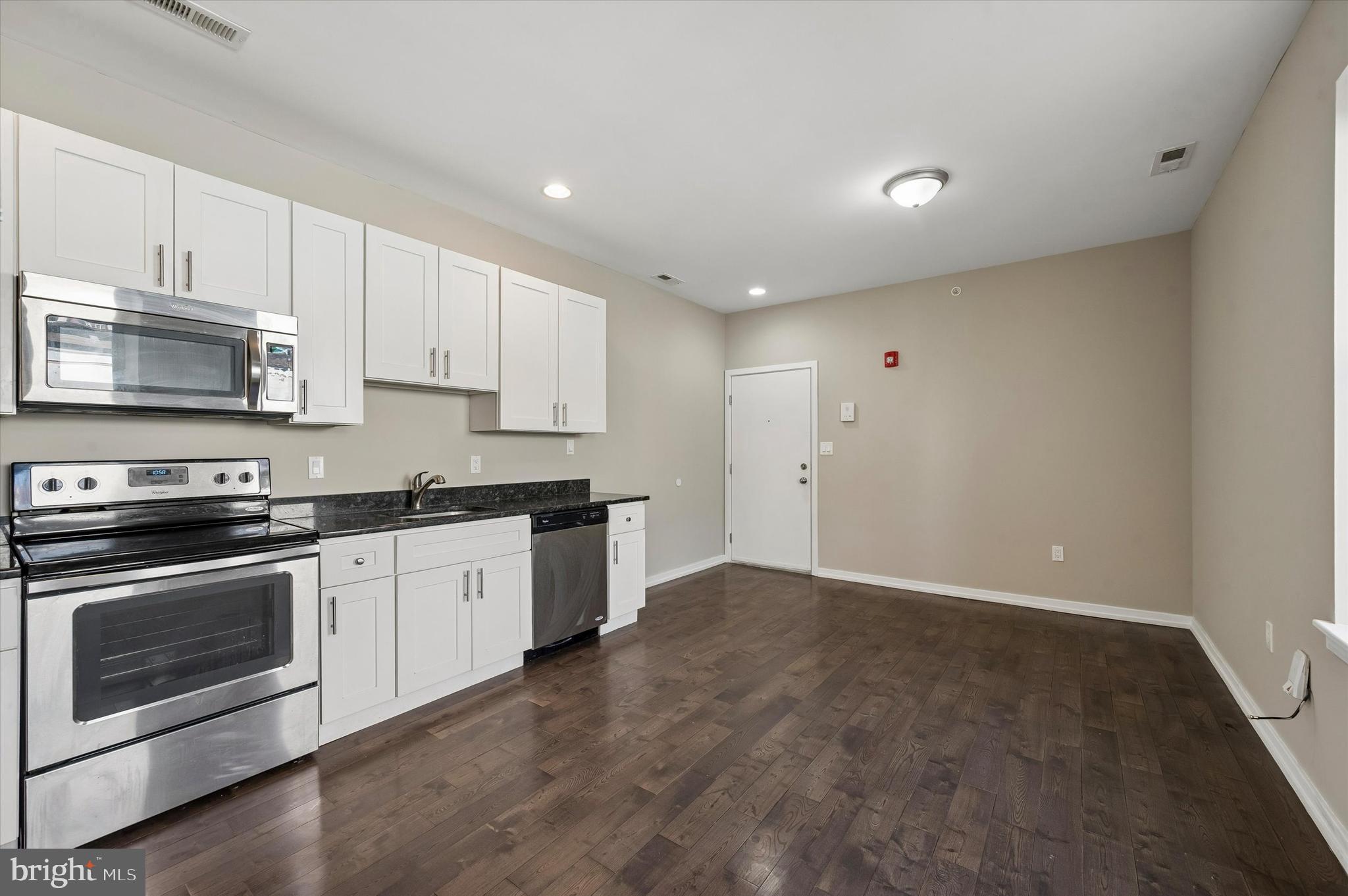 617 South 2nd Street, Unit 3R Philadelphia, PA 19147 - Photo 3 of 19 a kitchen with granite countertop a stove a sink and a microwave