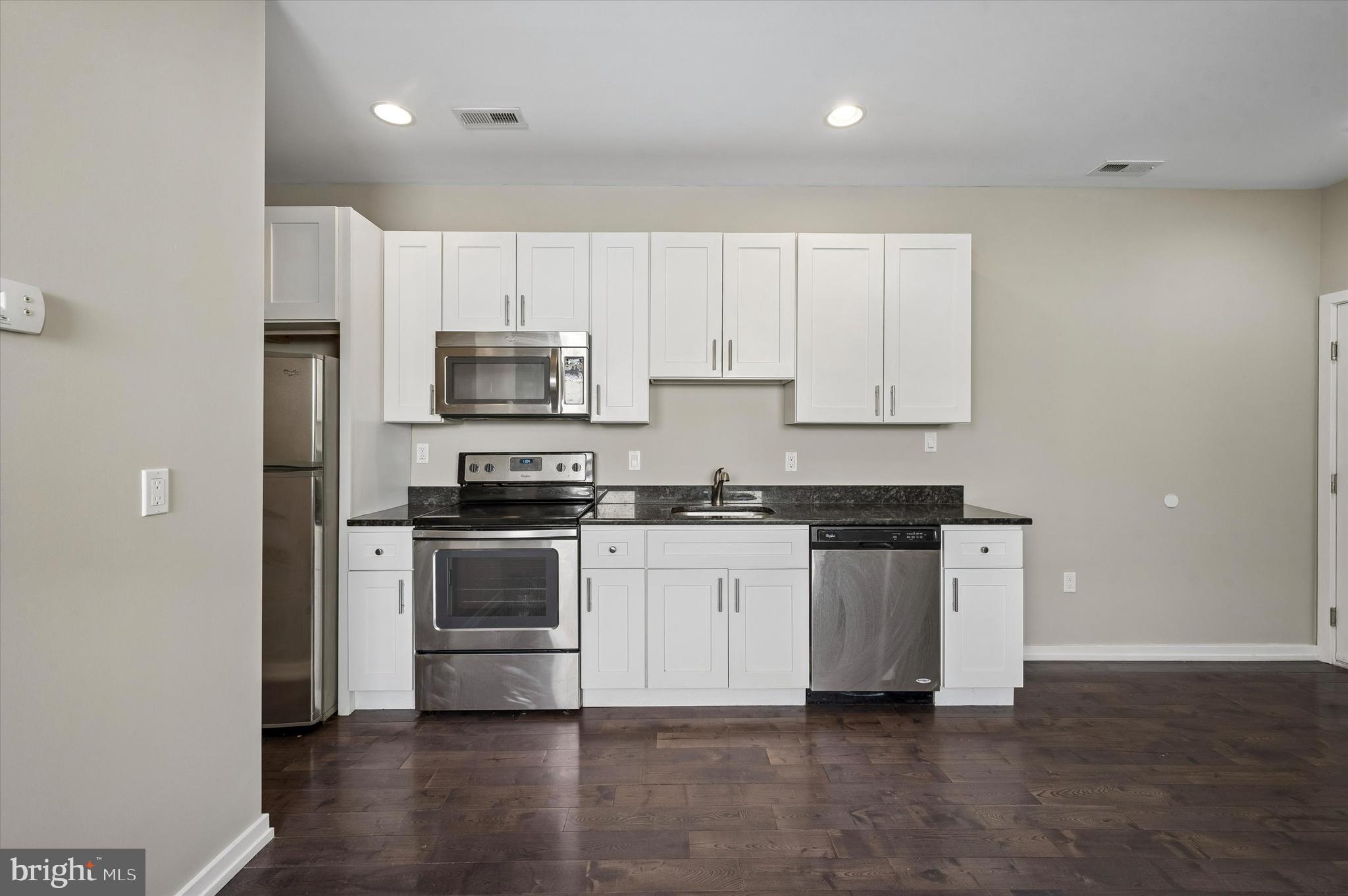 617 South 2nd Street, Unit 3R Philadelphia, PA 19147 - Photo 4 of 19 a kitchen with granite countertop white cabinets and stainless steel appliances
