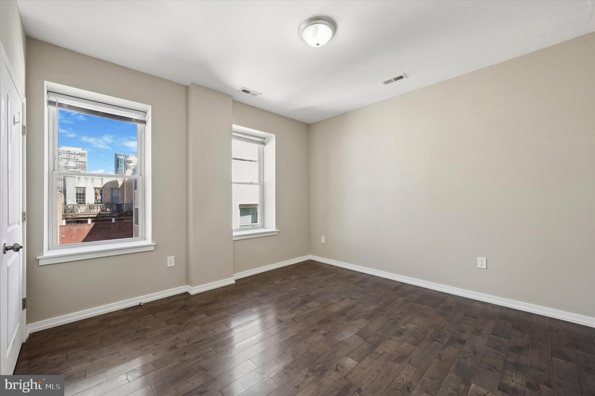 617 South 2nd Street, Unit 3R Philadelphia, PA 19147 - Photo 10 of 19 an empty room with wooden floor and windows