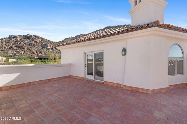 a view of a white house next to a road