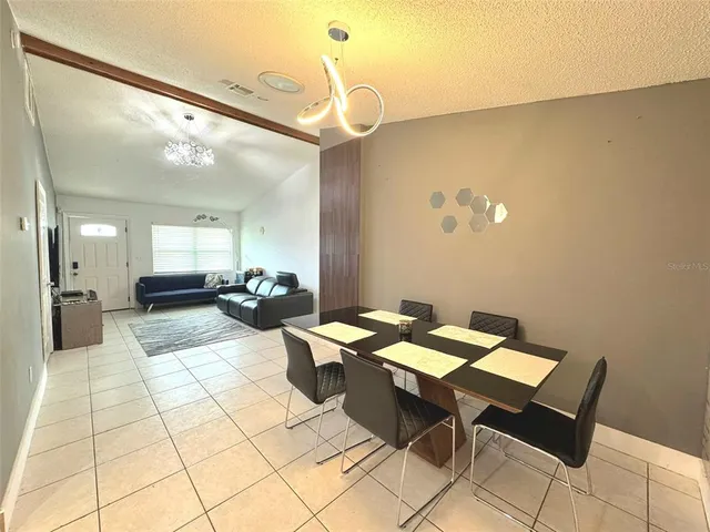 a kitchen with granite countertop a refrigerator and a sink
