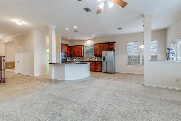 a view of a kitchen with a sink and a refrigerator