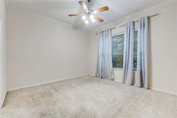 a bedroom with a bed couch and window