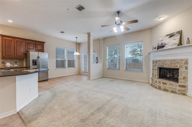 a view of a kitchen with a sink and a fireplace