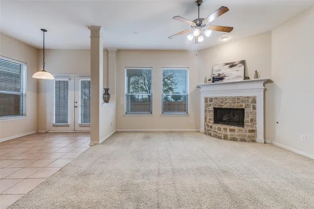 a view of an empty room with a fireplace and a window