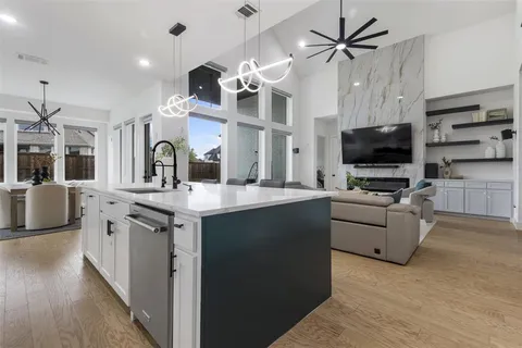 a kitchen with stainless steel appliances kitchen island granite countertop a stove and a sink