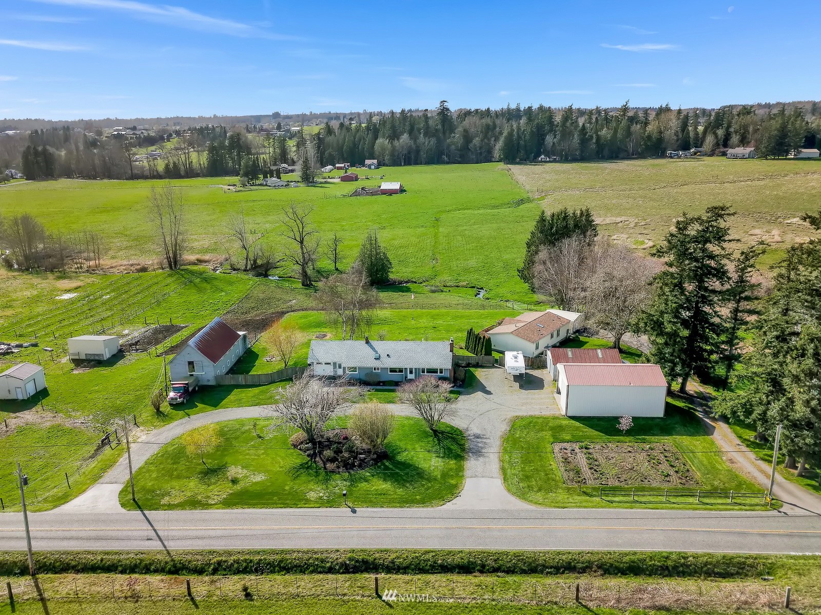5397 Olson Road Ferndale, WA 98248 - Photo 1 of 40 an aerial view of a house with outdoor space swimming pool outdoor seating and yard
