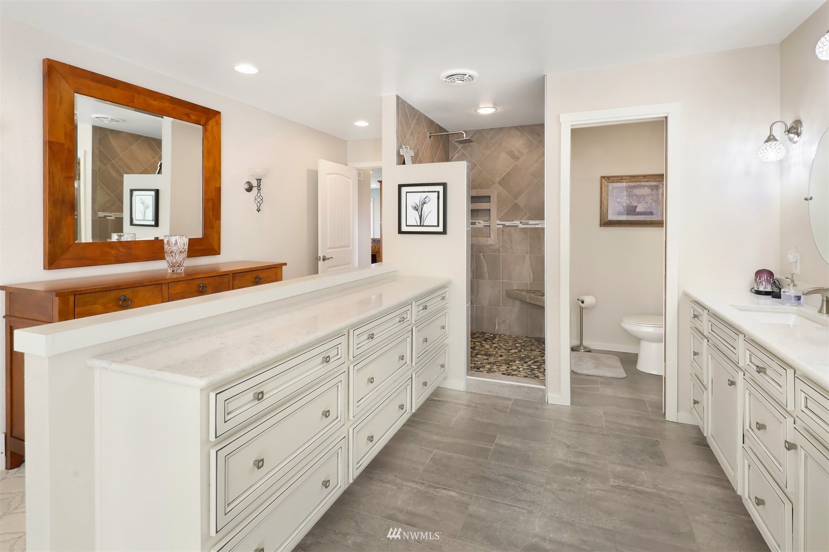 5397 Olson Road Ferndale, WA 98248 - Photo 9 of 40 a spacious bathroom with a double vanity sink a large mirror a toilet and a shower