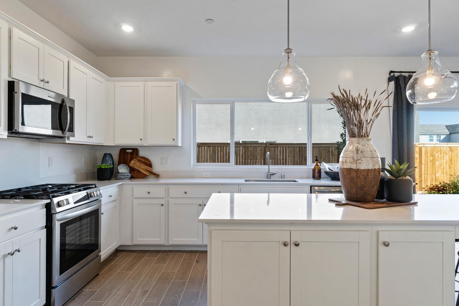 1059 Springtime Avenue Clovis, CA 93619 - Photo 15 of 32 a kitchen with stainless steel appliances granite countertop a sink a stove a microwave a center island and cabinets