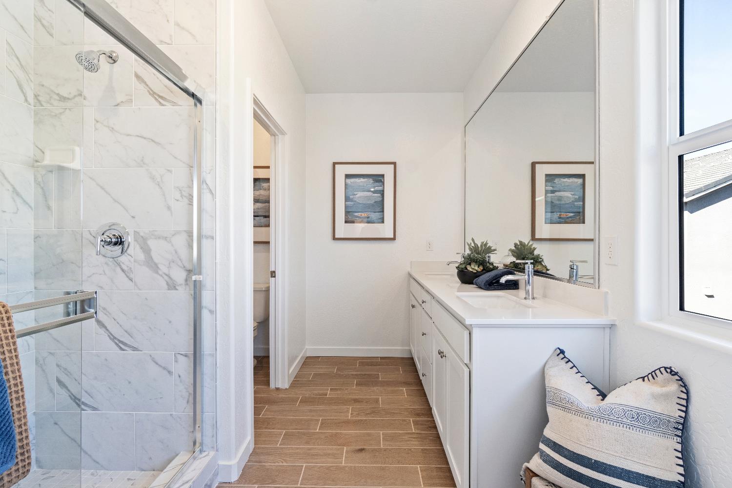 1059 Springtime Avenue Clovis, CA 93619 - Photo 21 of 32 a bathroom with a sink a mirror and a shower