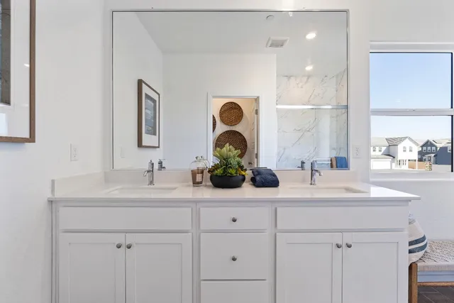 a bathroom with a double vanity sink and mirror