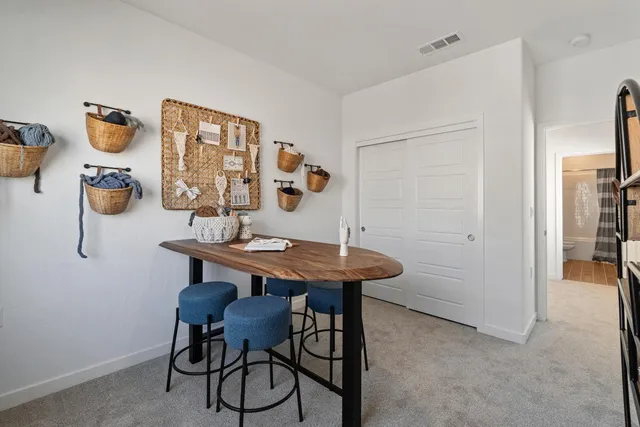 a view of a room that has a table and chairs in it