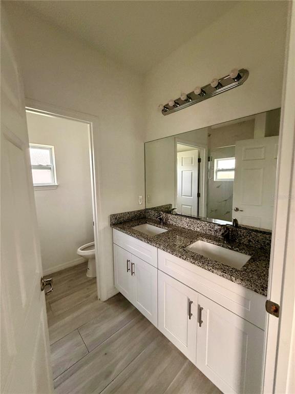 14142 Appleton Boulevard Port Charlotte, FL 33981 - Photo 12 of 26 a spacious bathroom with a granite countertop sink and a mirror