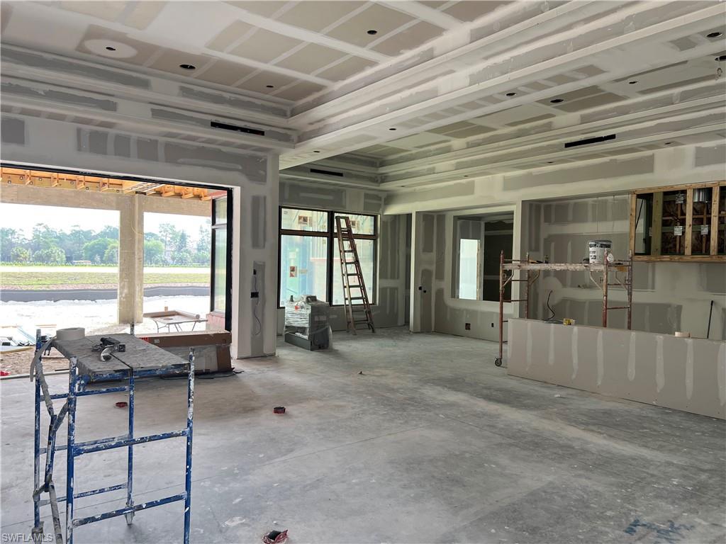 944 Chimney Rock Road Naples, FL 34120 - Photo 4 of 15 a living room with furniture and large windows