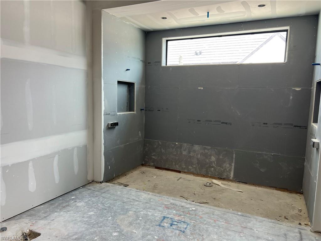 944 Chimney Rock Road Naples, FL 34120 - Photo 8 of 15 a bathroom with a bathtub and shower