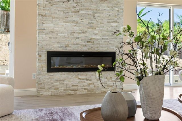 a living room with furniture and large windows