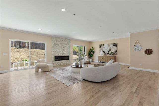 a kitchen with a sink stainless steel appliances and white cabinets