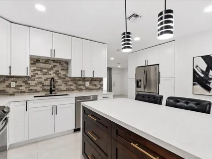 a kitchen with a sink and cabinets