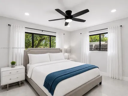 a bedroom with a large bed and a window