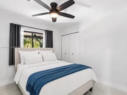 a bedroom with a large bed and a window