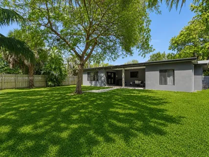 a front view of house with a garden