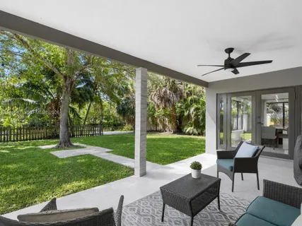 a view of a patio with couches chairs and a yard