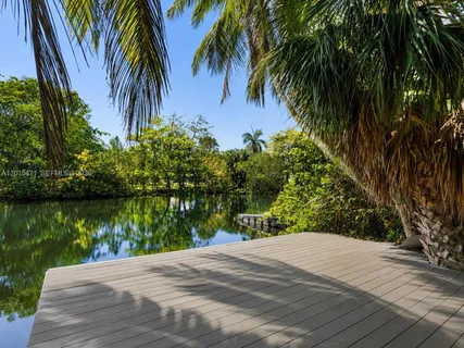 a view of a backyard of a house with a lake view