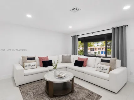 a living room with furniture and a large window