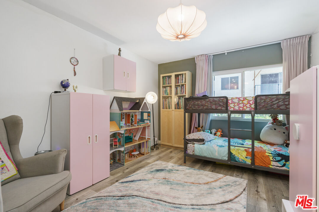 5460 White Oak Avenue, Unit A122 Encino, CA 91316 - Photo 11 of 19 a bedroom with furniture and a chandelier