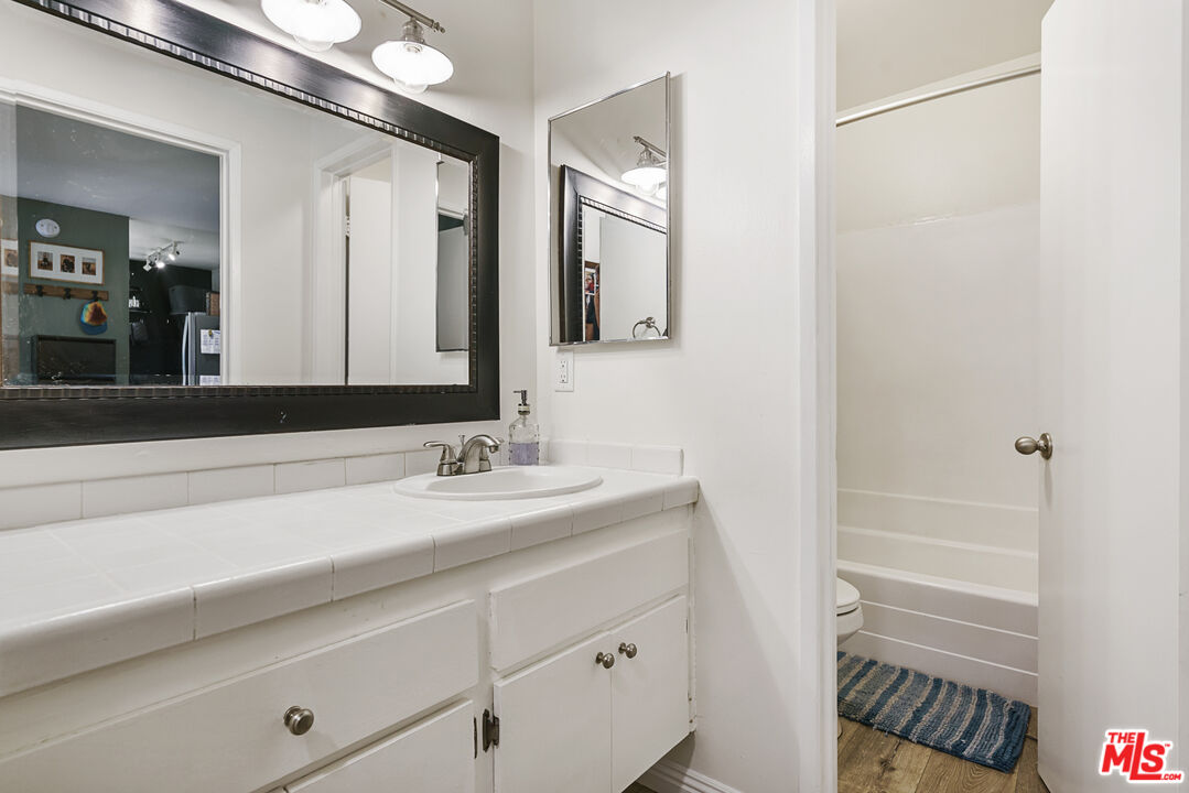 5460 White Oak Avenue, Unit A122 Encino, CA 91316 - Photo 13 of 19 a bathroom with a sink and a mirror