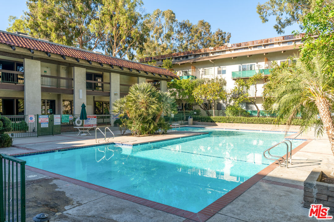 5460 White Oak Avenue, Unit A122 Encino, CA 91316 - Photo 16 of 19 a view of a patio with table and chairs and potted plants