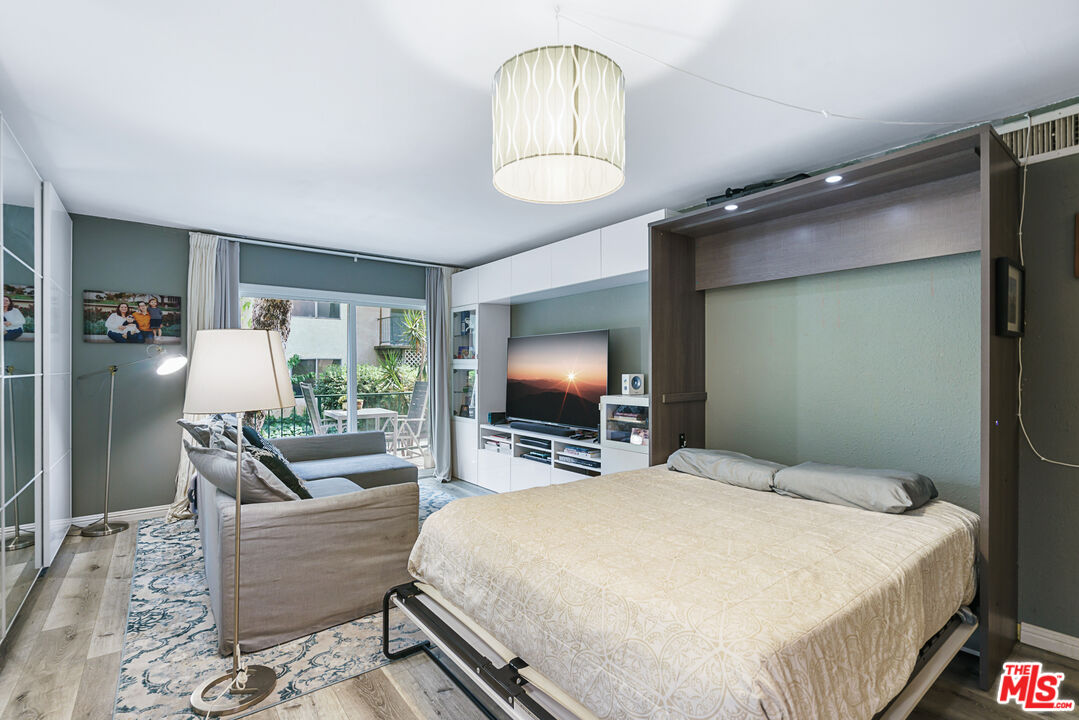 5460 White Oak Avenue, Unit A122 Encino, CA 91316 - Photo 5 of 19 a bedroom with a bed window and couch