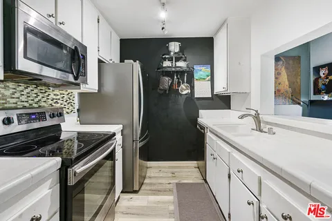 a kitchen with a stove and a microwave