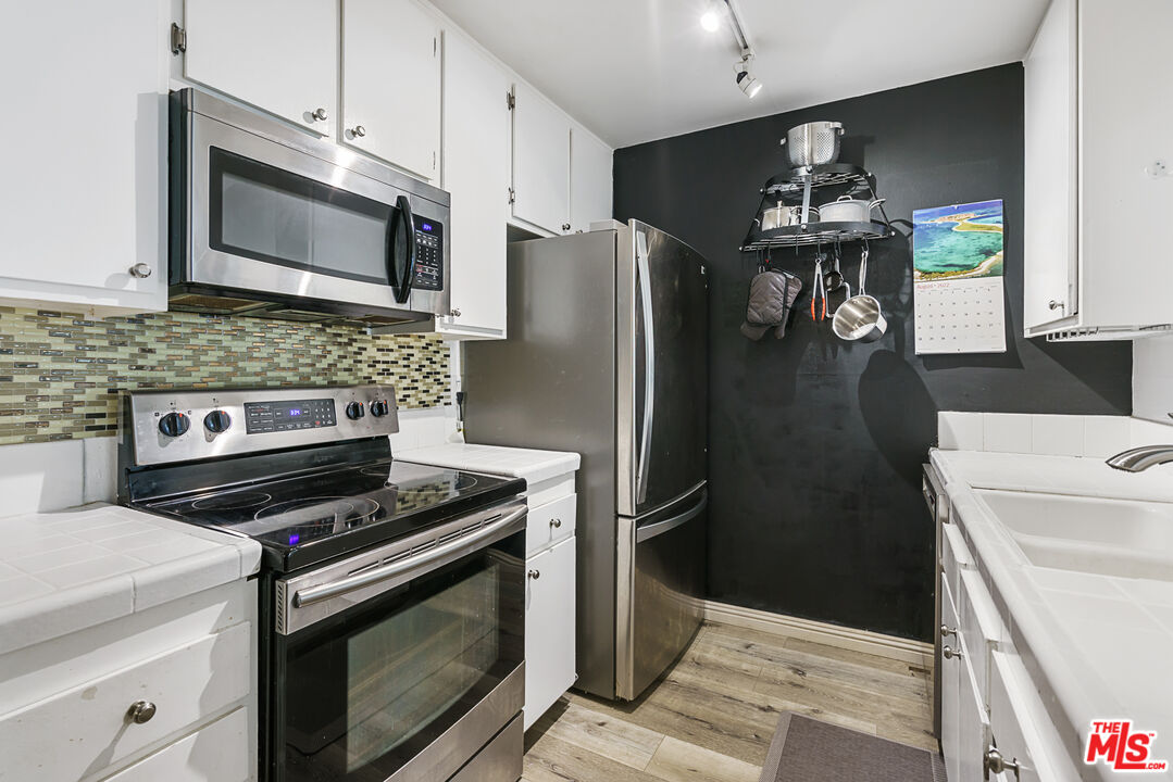 5460 White Oak Avenue, Unit A122 Encino, CA 91316 - Photo 9 of 19 a kitchen with a stove and a microwave
