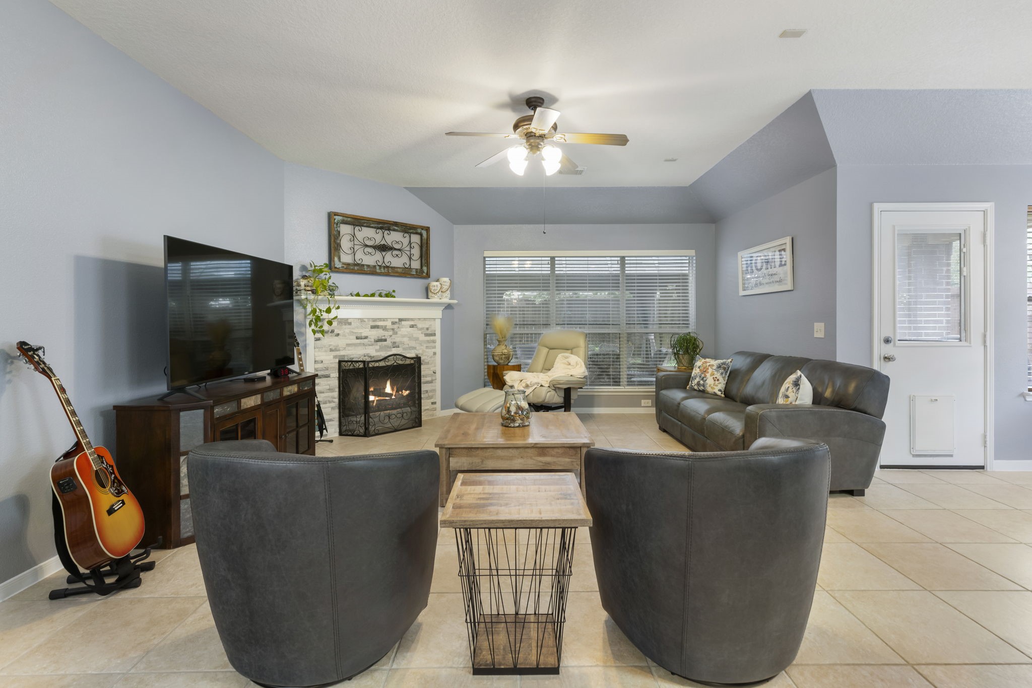 20019 Hardsville Drive Spring, TX 77388 - Photo 11 of 28 a living room with furniture a flat screen tv and a fireplace